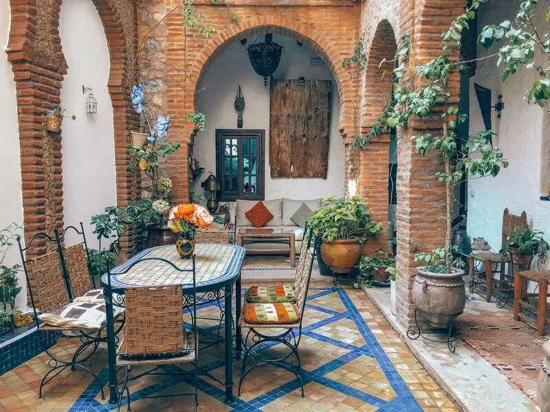 Luxury Moroccan riad courtyard with intricate tilework and fountain